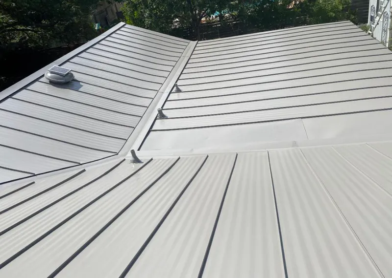 Solar attic fan installed on a metal roof for Roof Ventilation in Mamaroneck